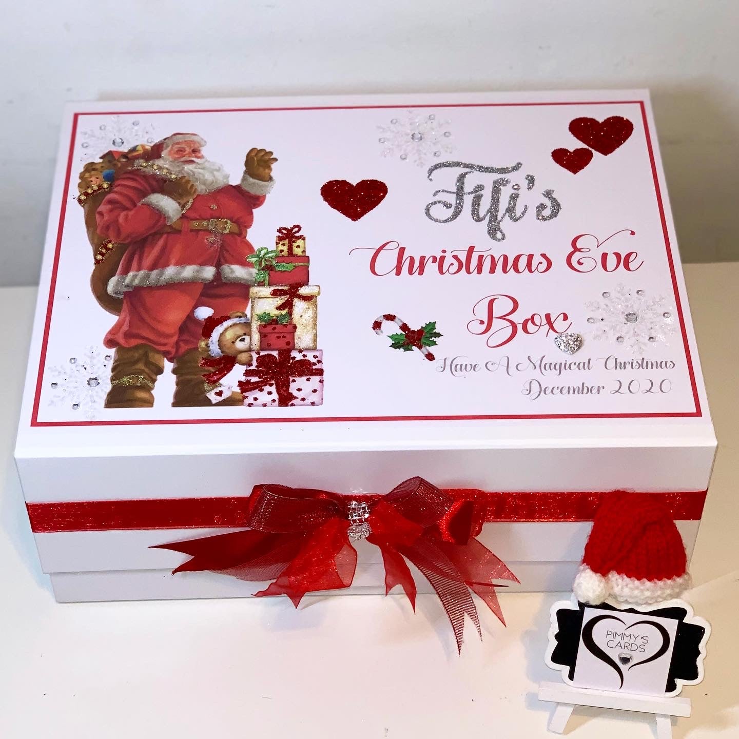 Personalised Christmas Eve box with traditional father Christmas design and red ribbon.