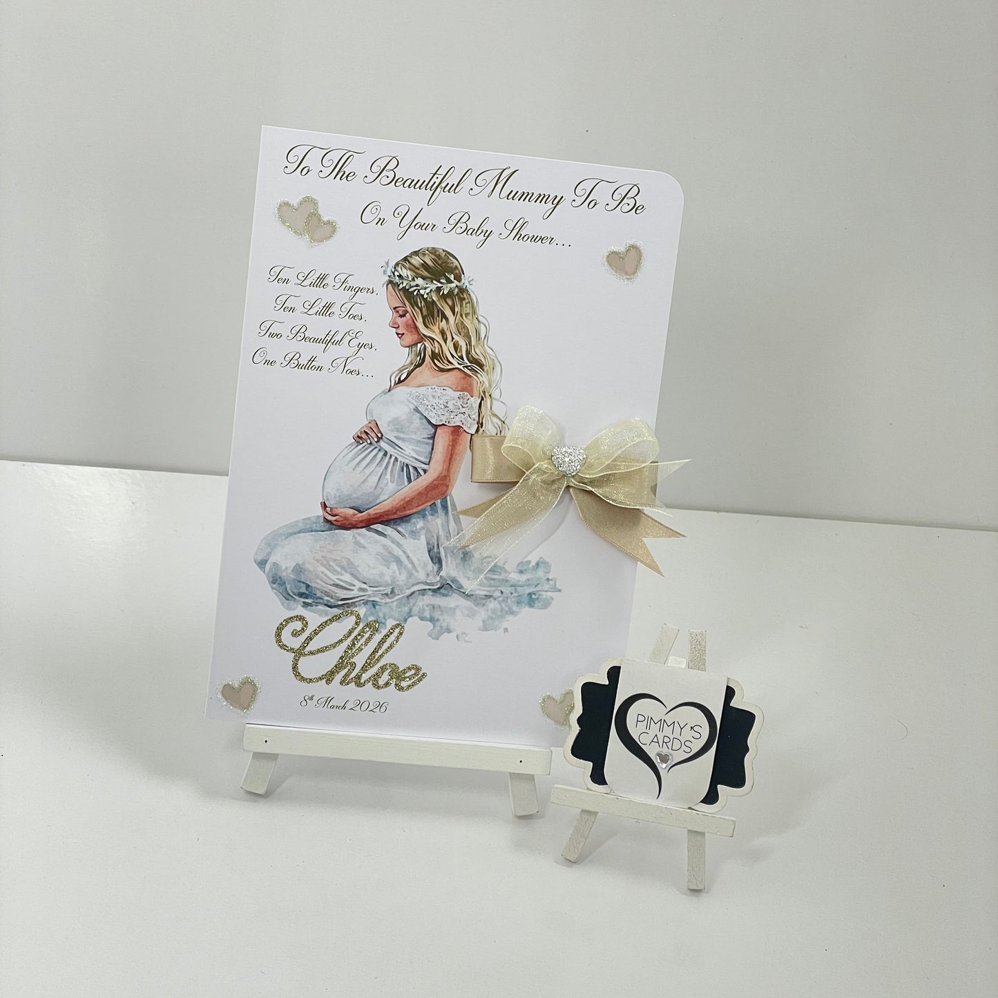 Lady holding her bump in white gown Baby shower