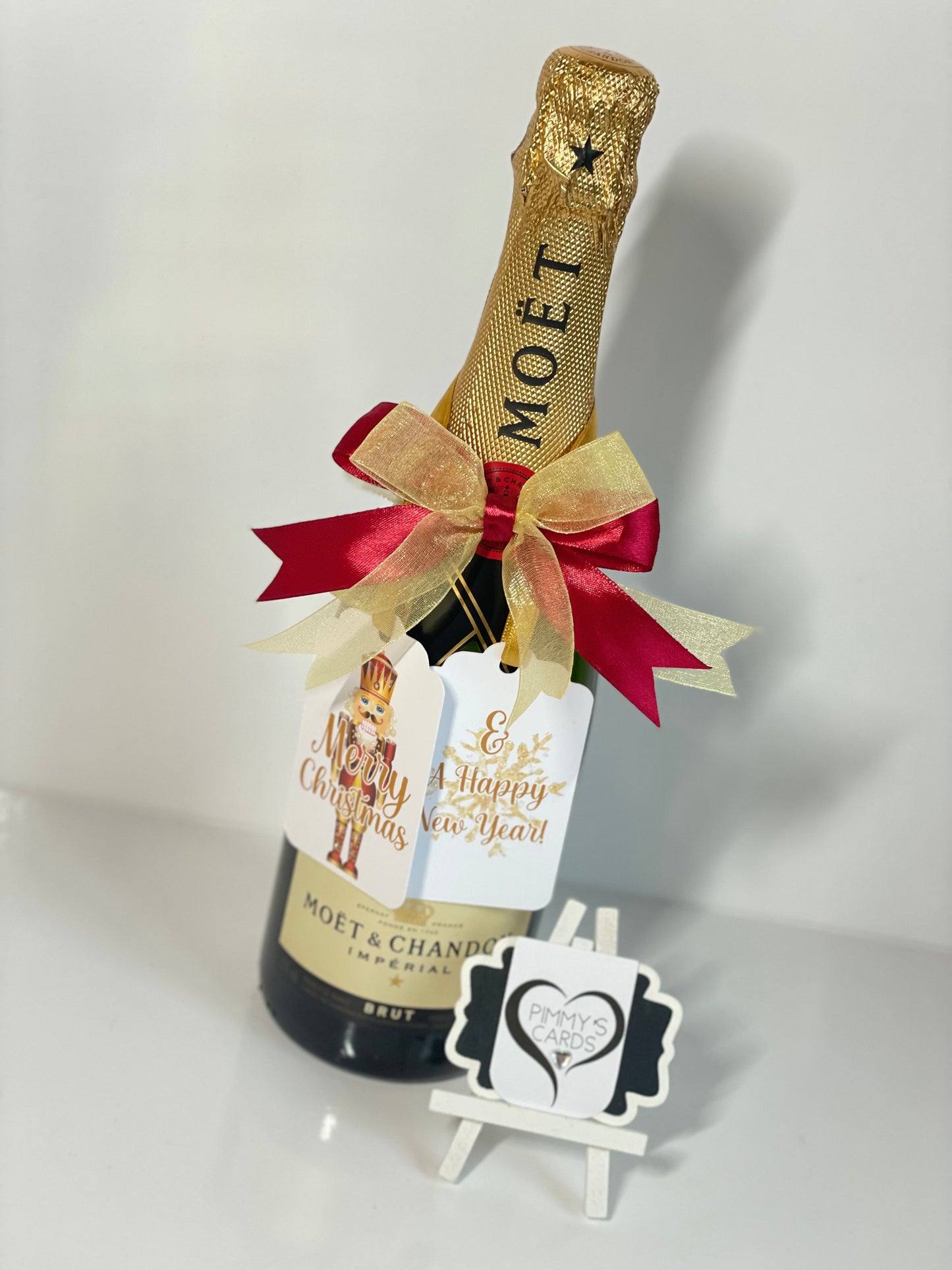 Personalised Bottle Tag for Christmas present. Moët champagne bottle with decorative bow and gift tag bottle tag and New Year's tag.