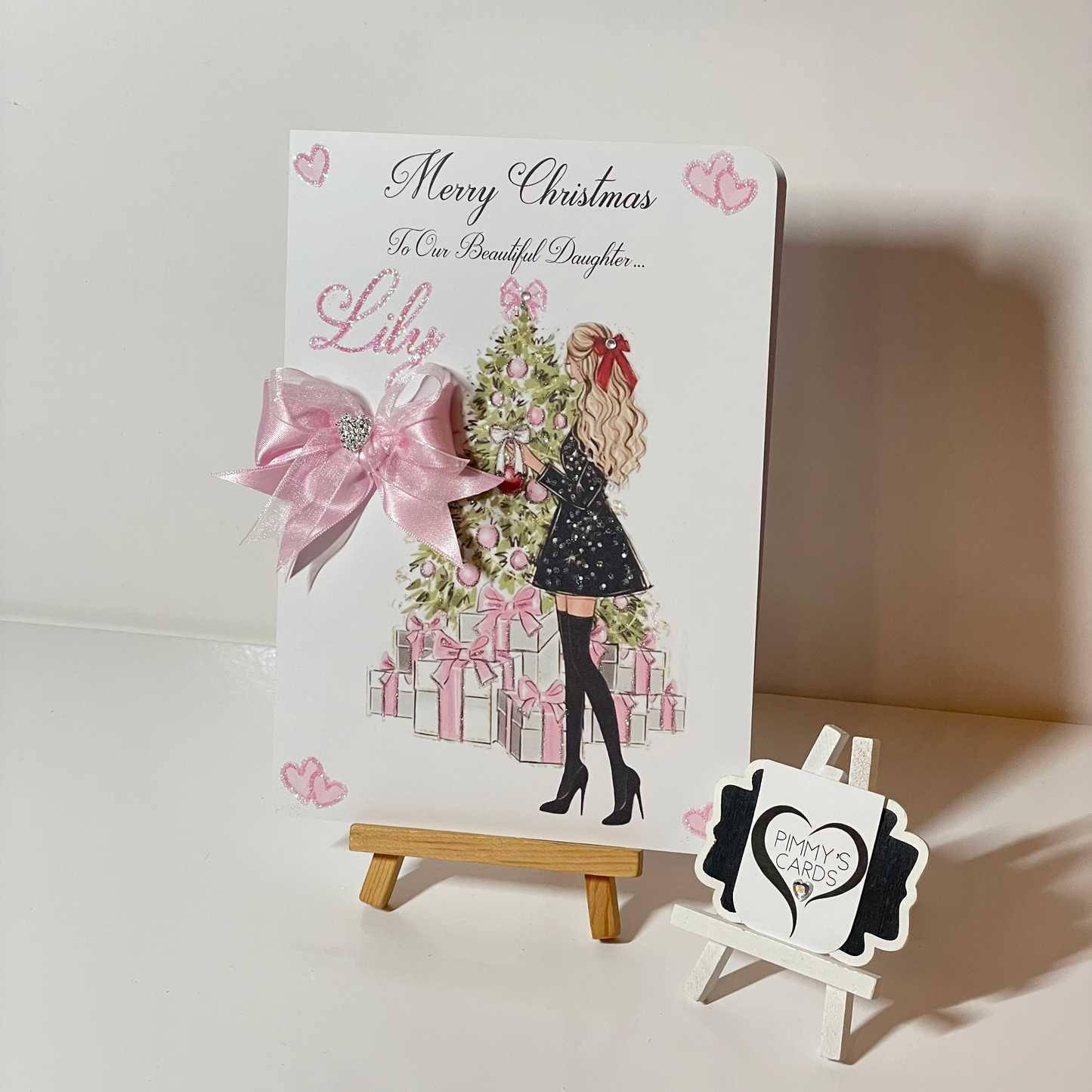 Pink Christmas personalised cards. Lady at Christmas tree with pink presents.