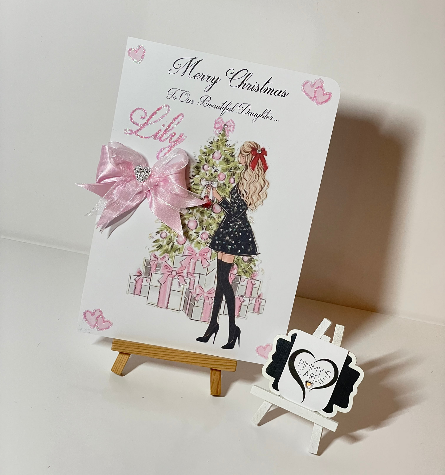 Pink Christmas personalised cards. Lady at Christmas tree with pink presents.