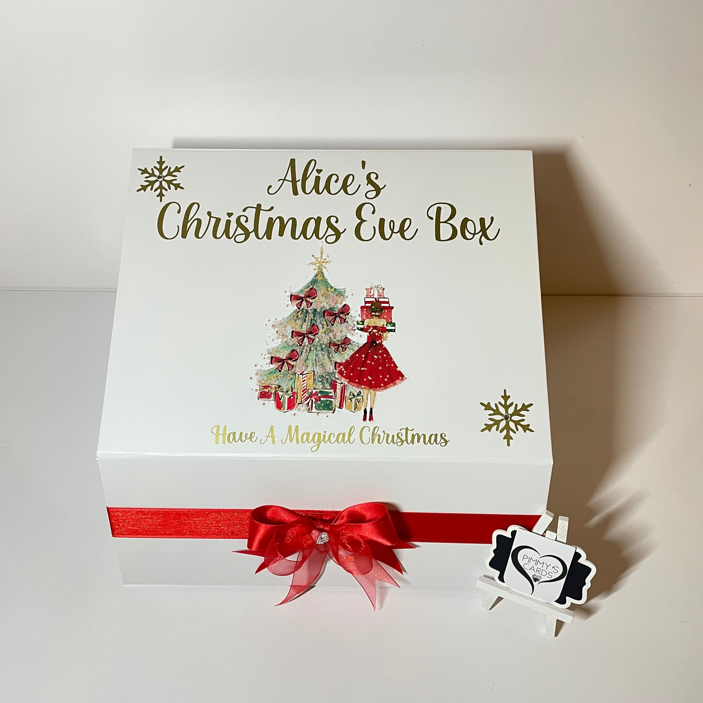 Personalised Christmas Eve box with festive design and red ribbon.