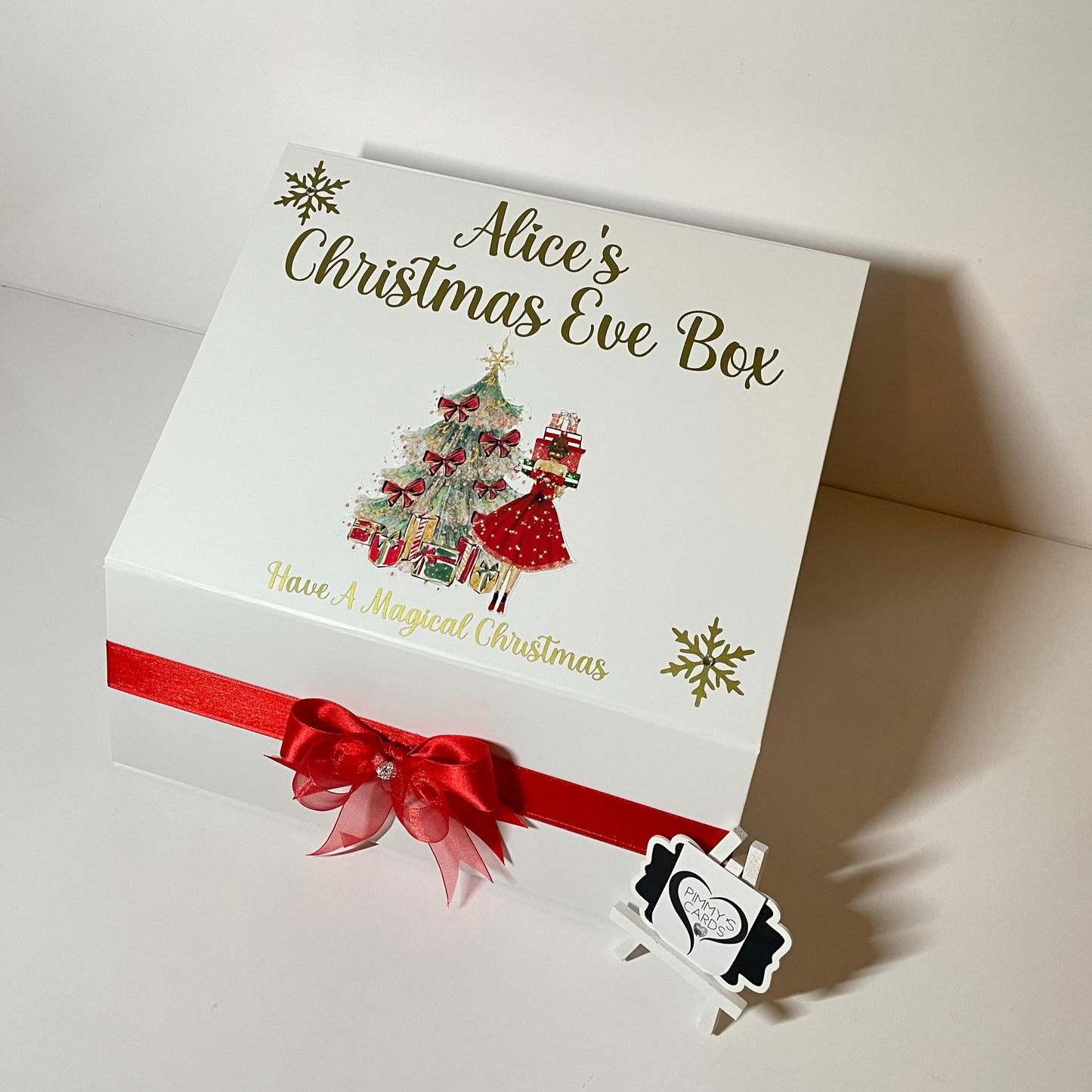 Personalised Christmas Eve box with festive design and red ribbon.
