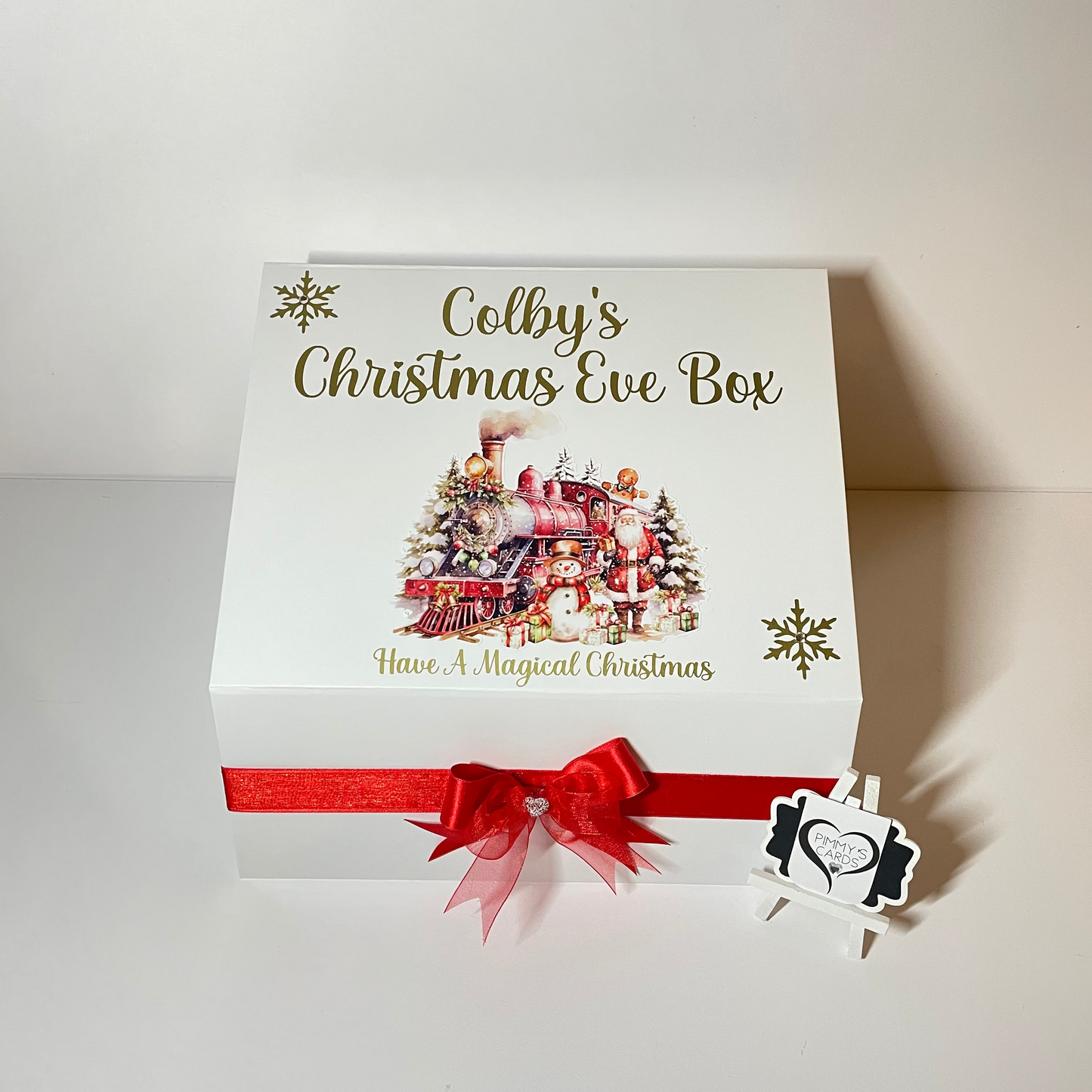 Personalised Christmas Eve box with festive design and red ribbon.