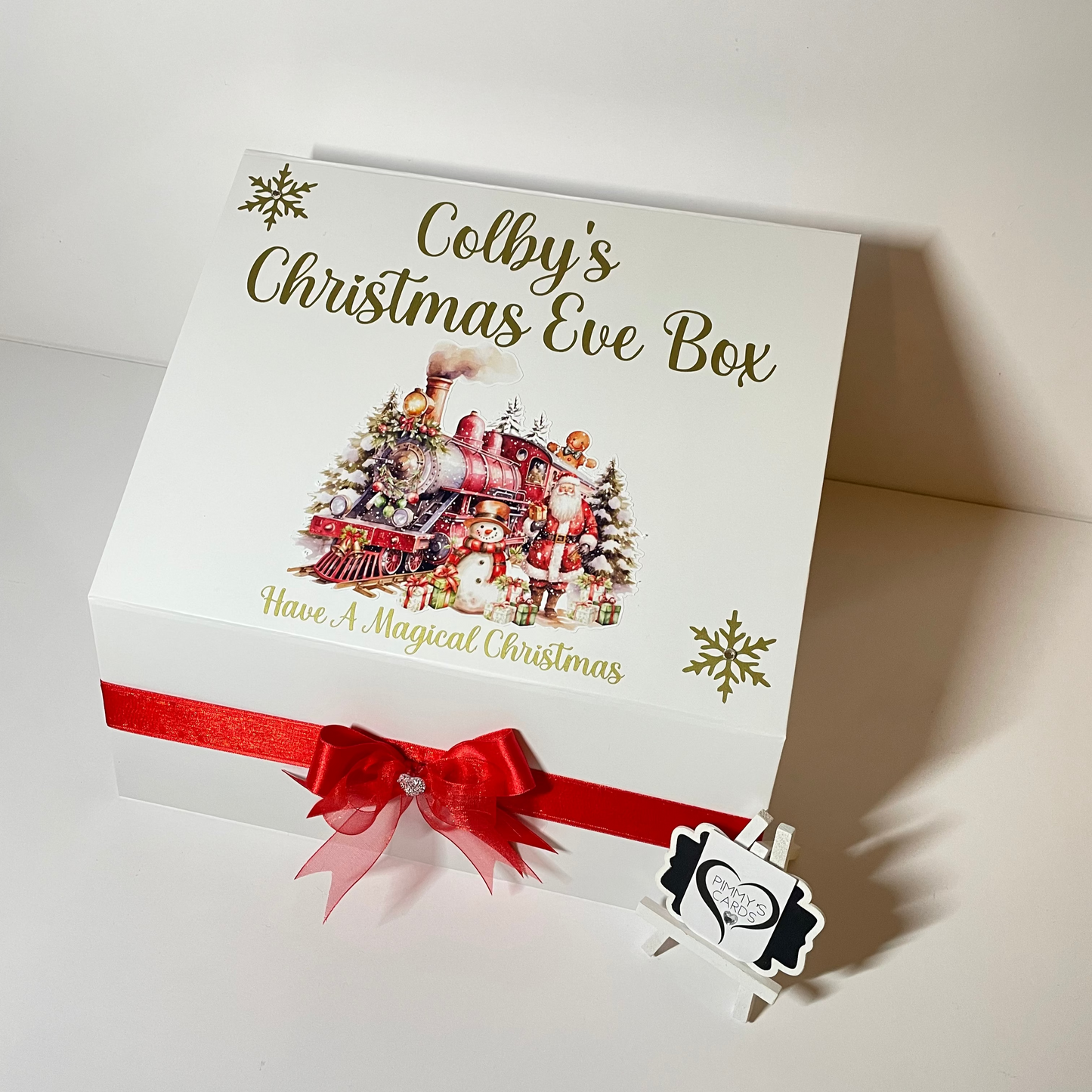 Personalised Christmas Eve box with festive design and red ribbon.