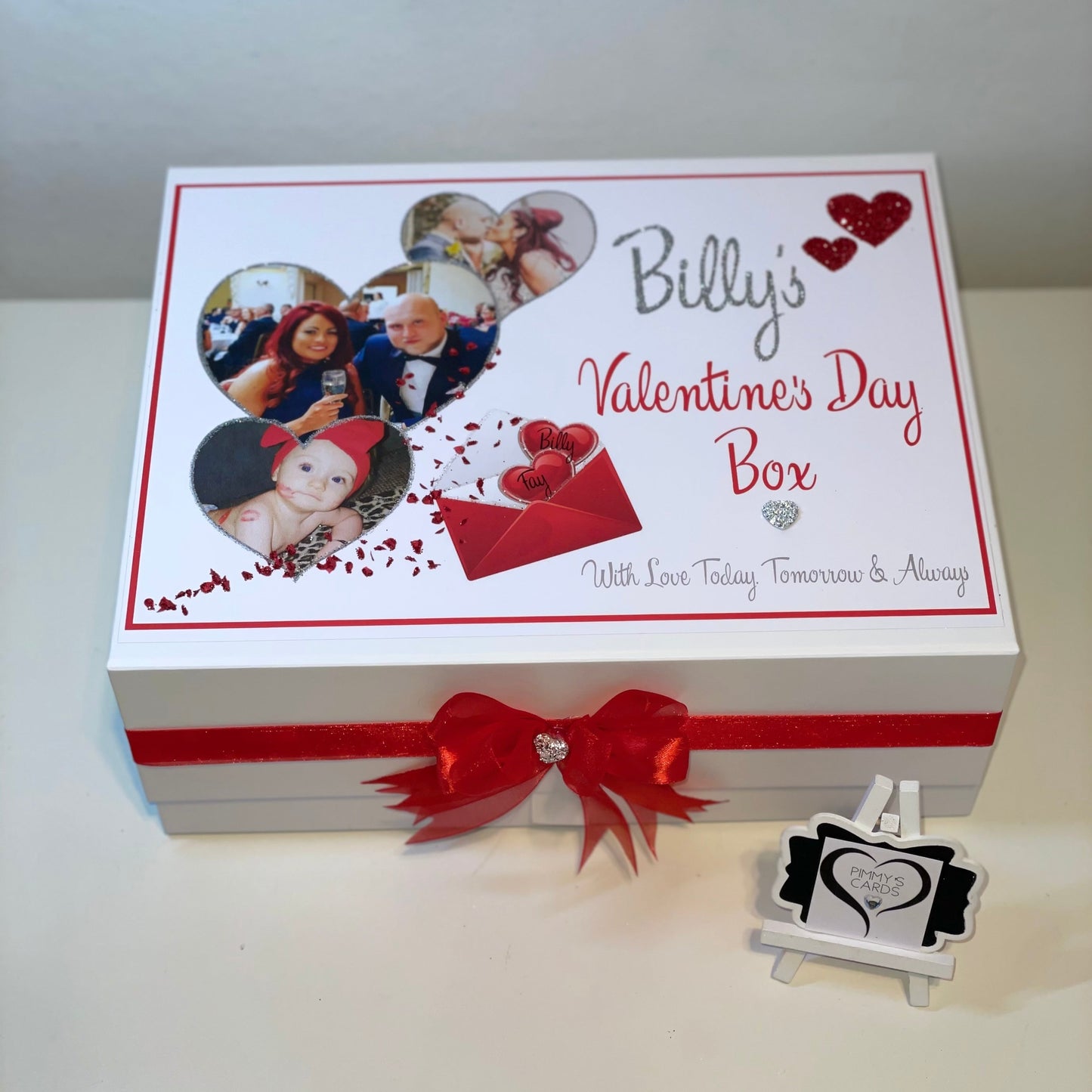 Valentine's Day themed box with a red ribbon and personalized photos on a white background