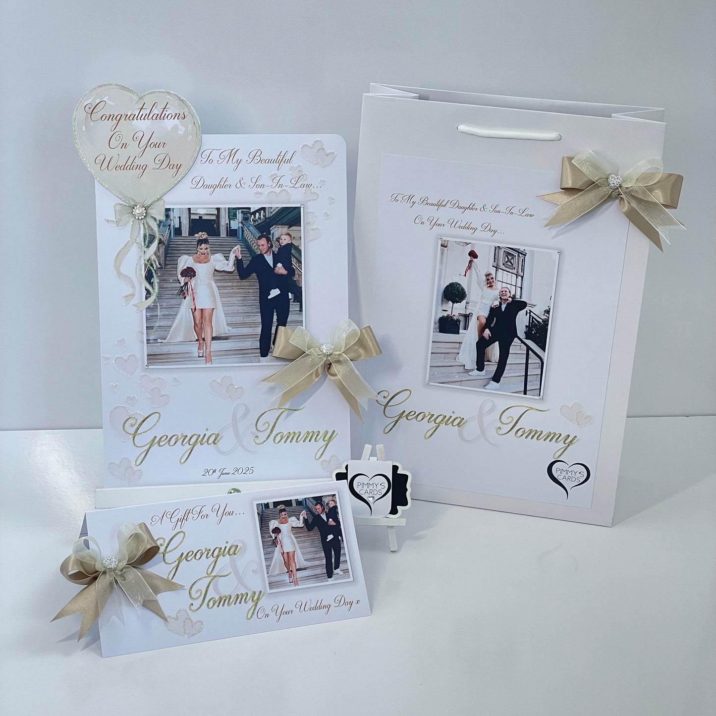 Personalised wedding photo card of Georgia Kousoulou & Tommy Mallet Gold theme with bow