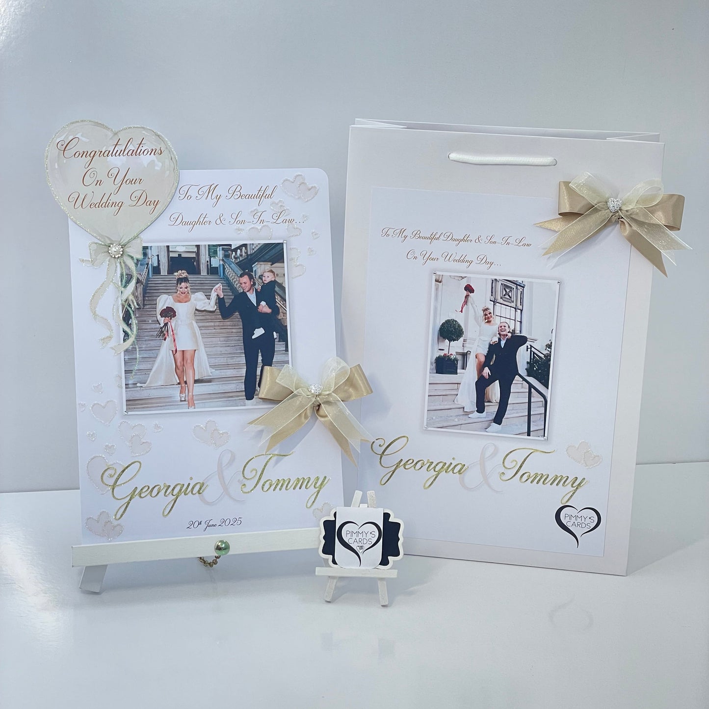 Personalised wedding photo card of Georgia Kousoulou & Tommy Mallet Gold theme with bow