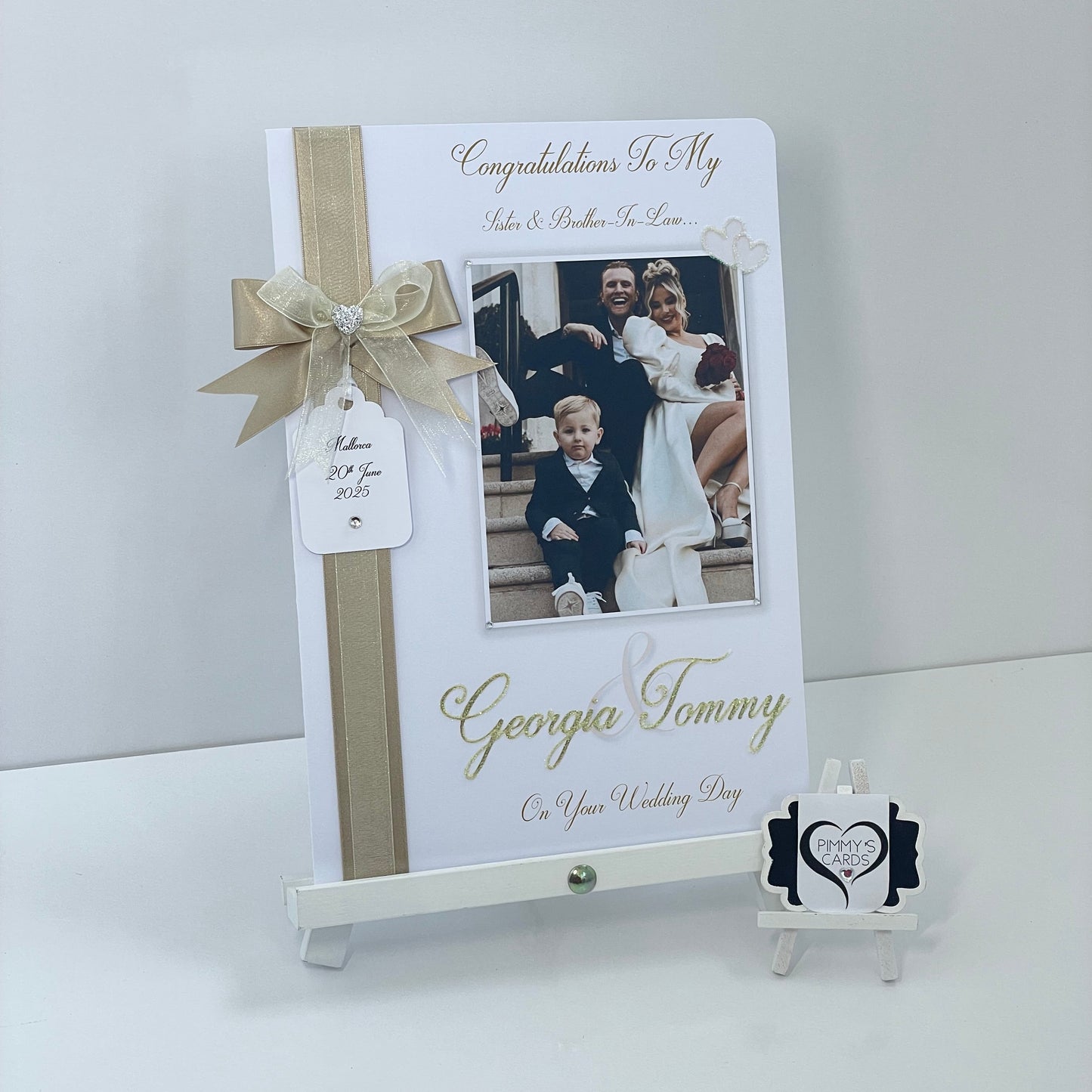 Personalised wedding photo card of Georgia Kousoulou & Tommy Mallet Gold theme with bow