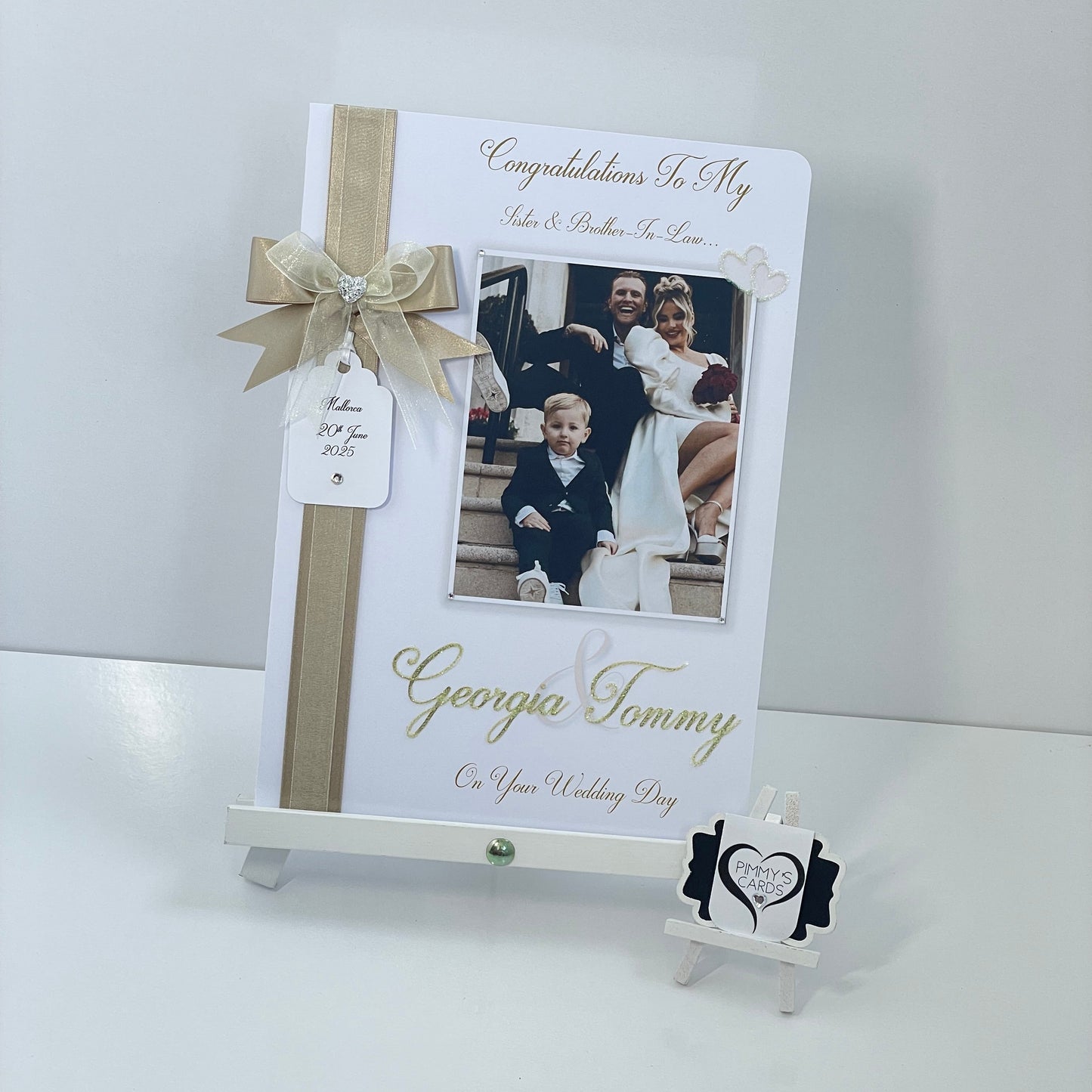 Personalised wedding photo card of Georgia Kousoulou & Tommy Mallet Gold theme with bow