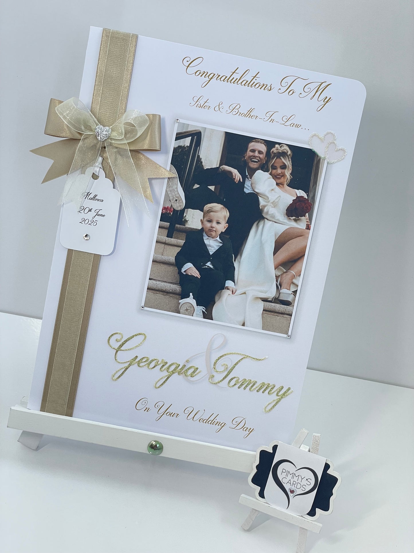 Personalised wedding photo card of Georgia Kousoulou & Tommy Mallet Gold theme with bow