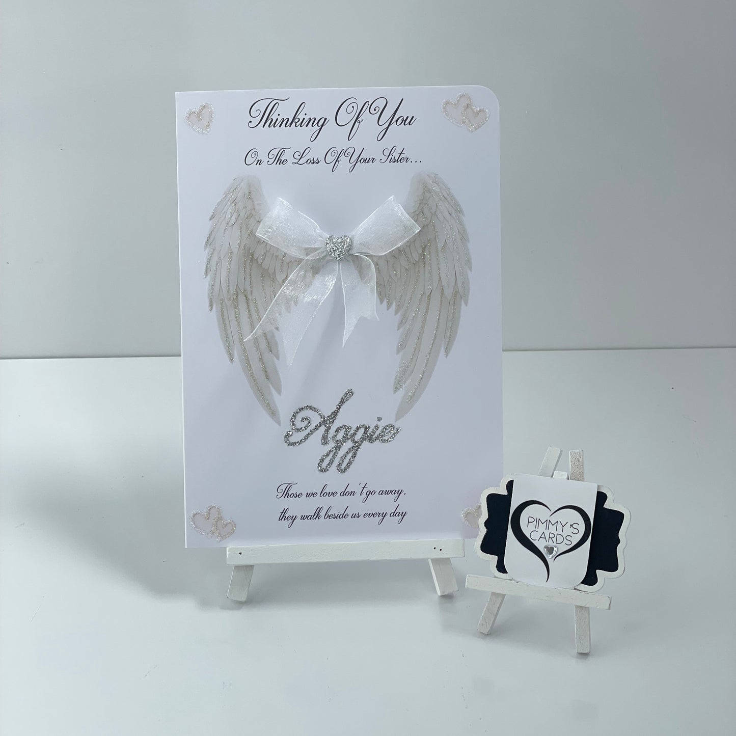 Memorial card with angel wing design and 'Thinking of You' message on a white background