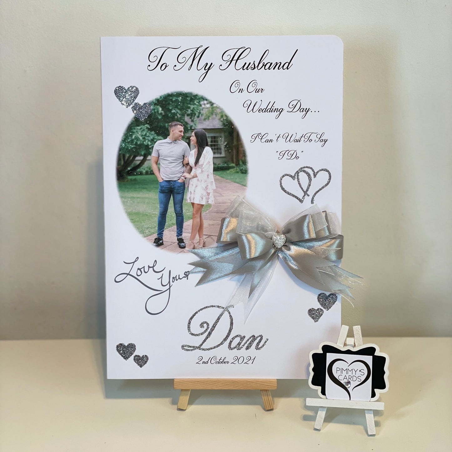 Personalized card for a husband on their wedding day with a ribbon and stand.