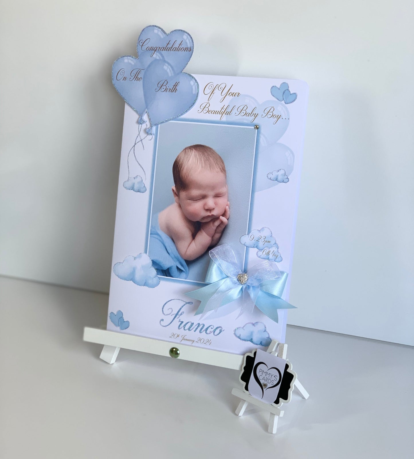 Baby photo frame with blue balloons and text on a white background