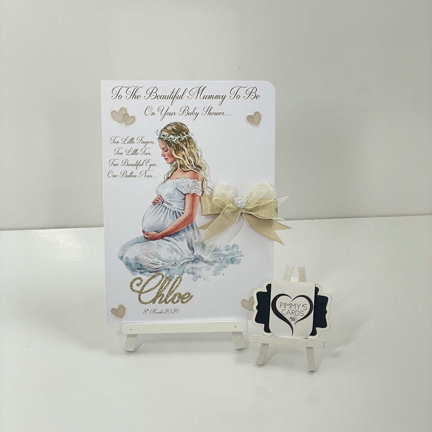 Lady holding her bump in white gown Baby shower