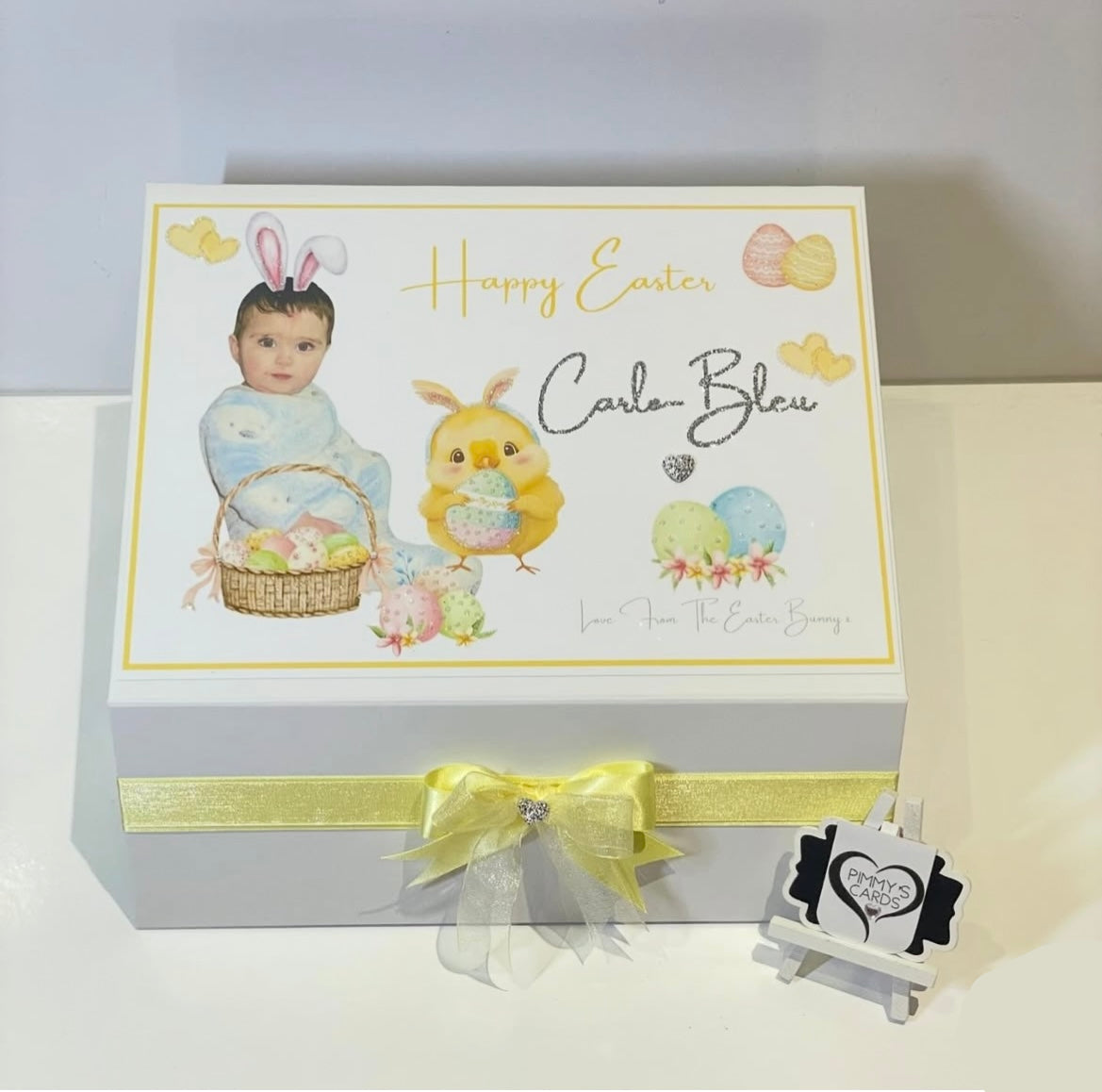 Easter-themed gift box with a baby illustration and decorative elements on a white background