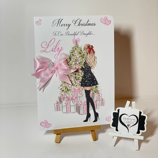 Pink Christmas personalised cards. Lady at Christmas tree with pink presents.