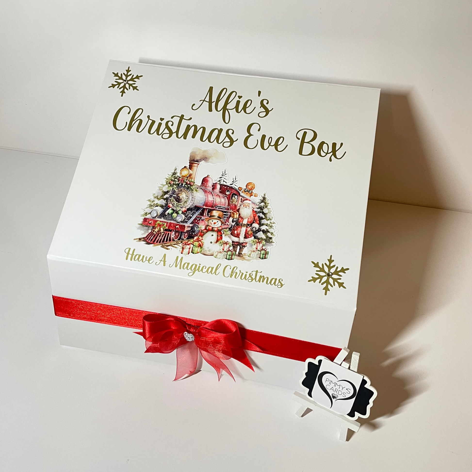 Personalised Christmas Eve box with festive design and red ribbon.