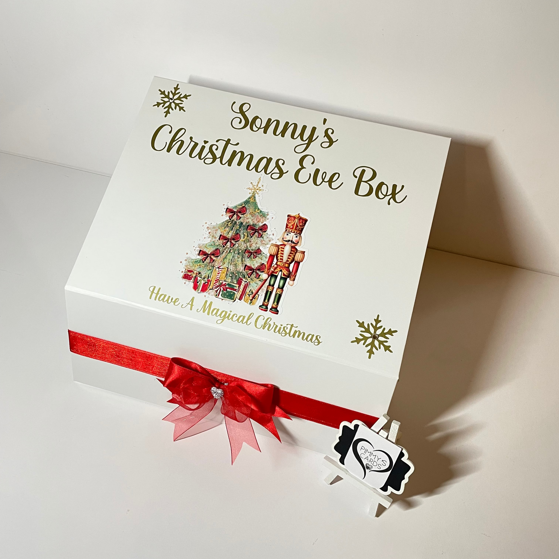 Personalised Christmas Eve box with festive design and red ribbon.