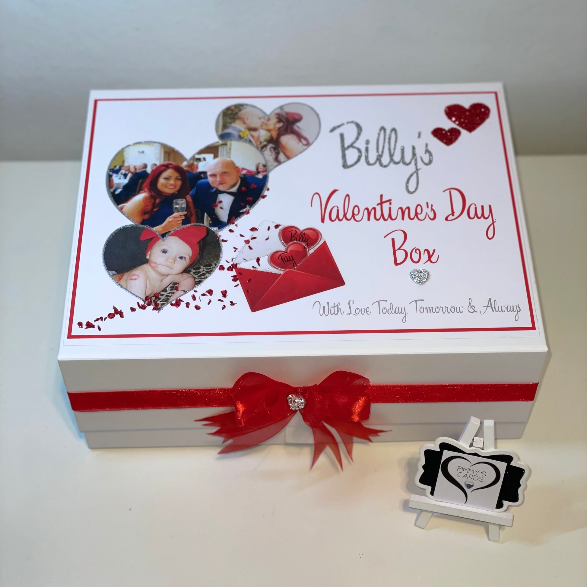 Valentine's Day themed box with a red ribbon and personalized photos on a white background