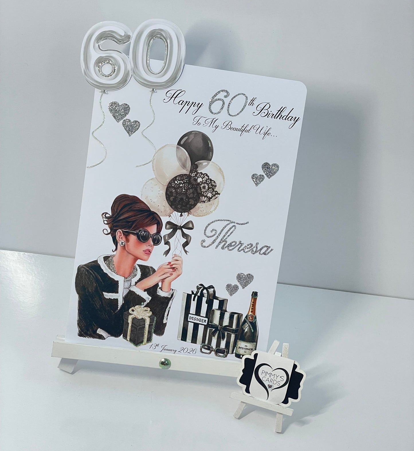 60th birthday card for a woman with a personalized message on a white stand.