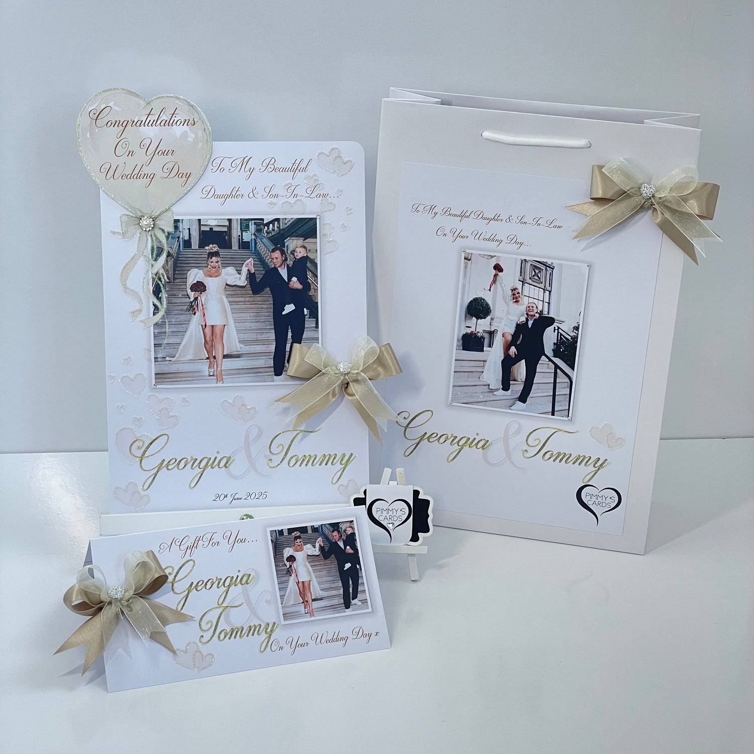 Personalised wedding photo card of Georgia Kousoulou & Tommy Mallet Gold theme with bow
