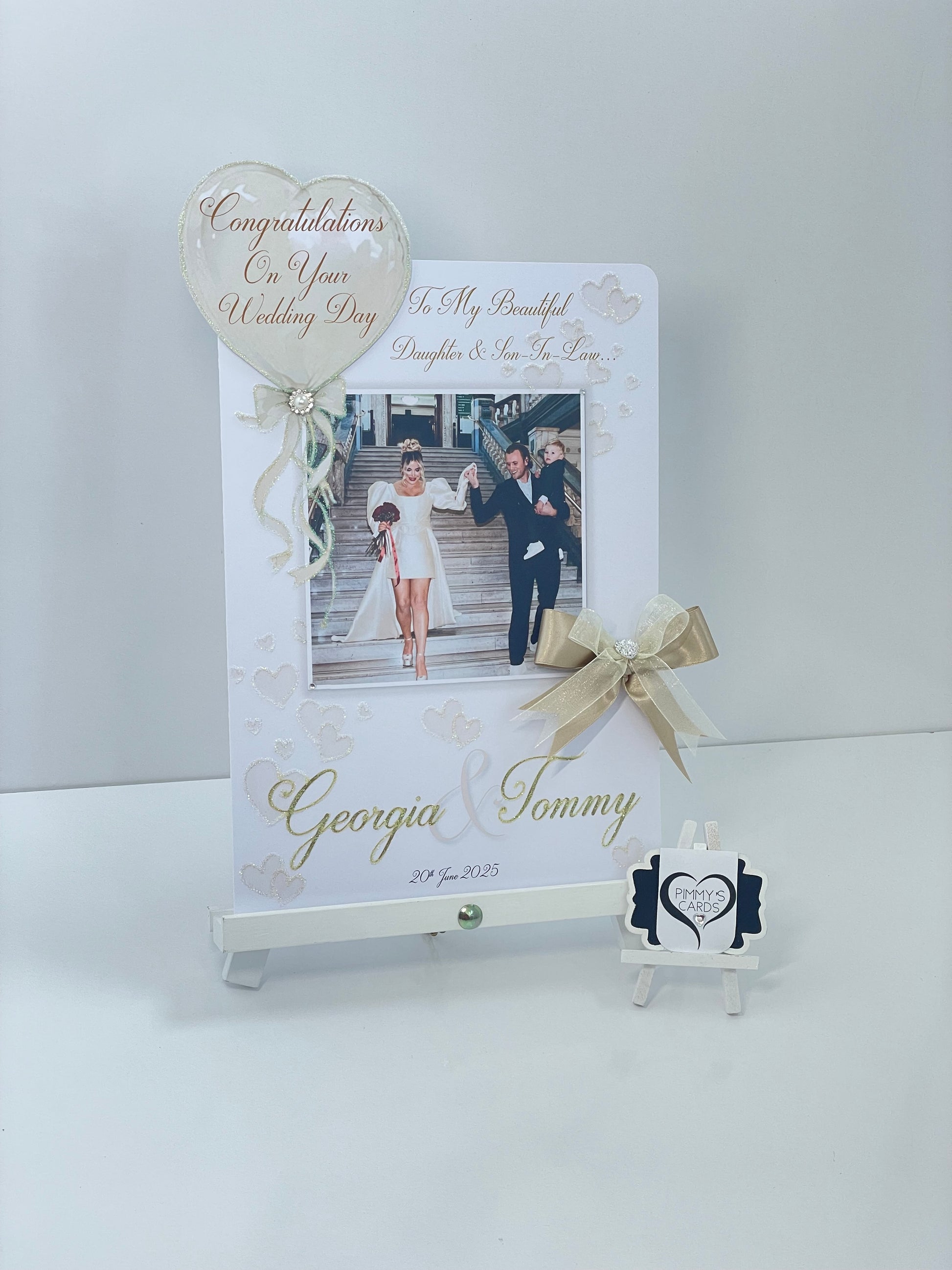 Personalised wedding photo card of Georgia Kousoulou & Tommy Mallet Gold theme with bow