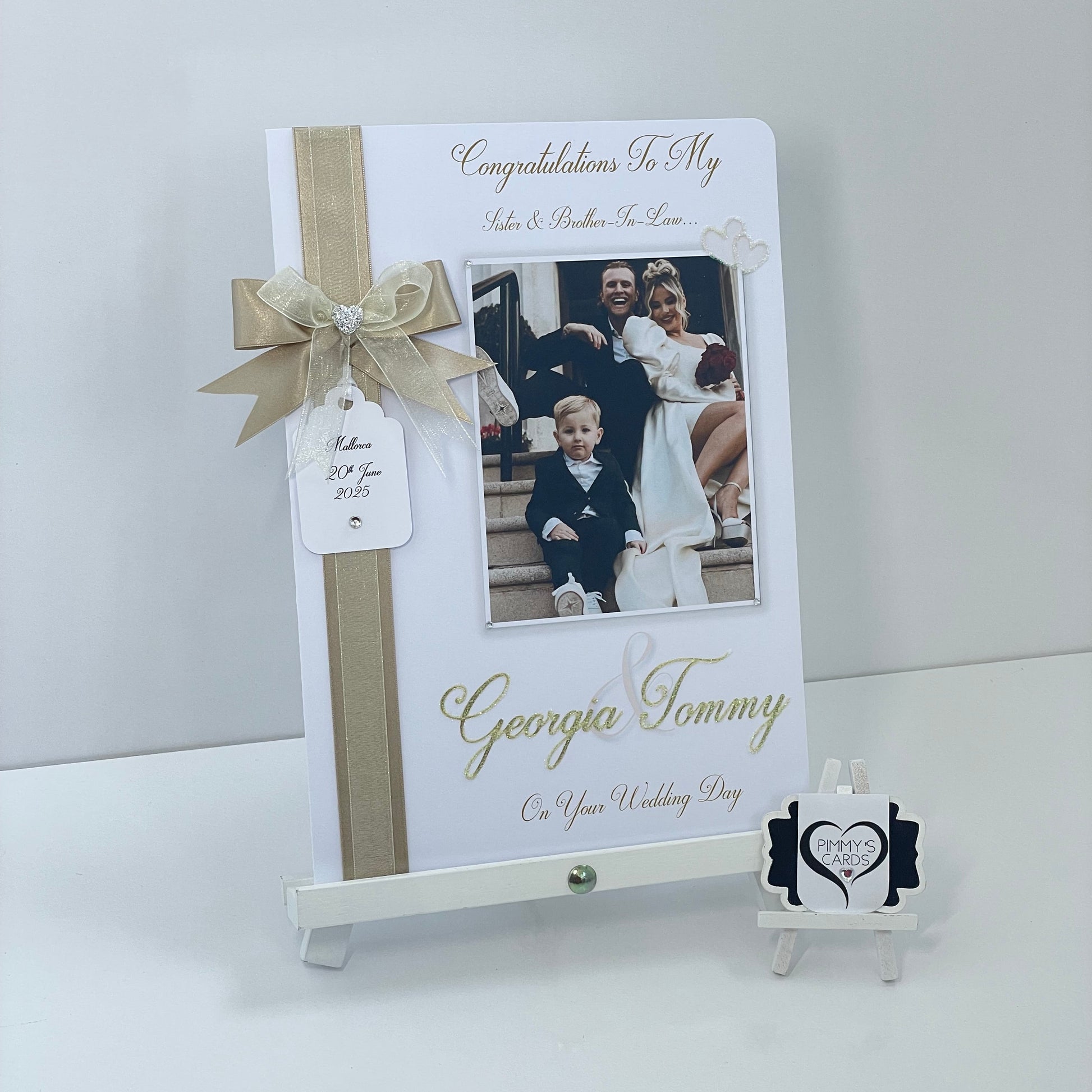 Personalised wedding photo card of Georgia Kousoulou & Tommy Mallet Gold theme with bow