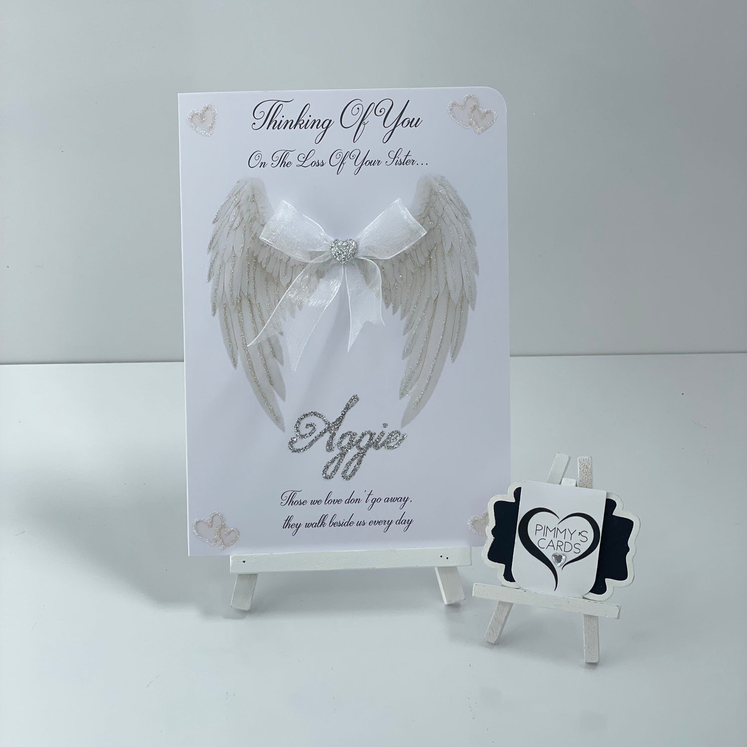 Memorial card with angel wing design and 'Thinking of You' message on a white background