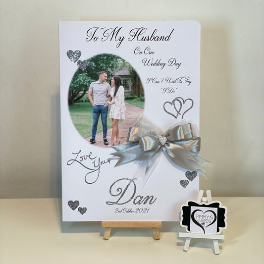 Personalized card for a husband on their wedding day with a ribbon and stand.