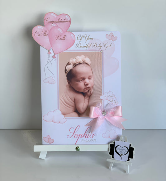 Baby photo frame with a newborn baby's picture and pink balloons on a white background