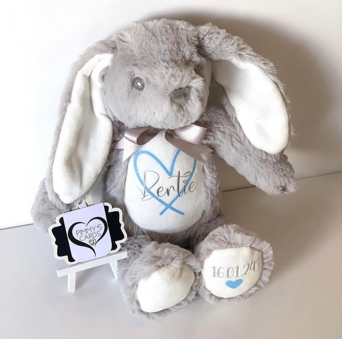 Grey plush bunny with personalised name and date text on it. Personalised Soft Toy Bunny