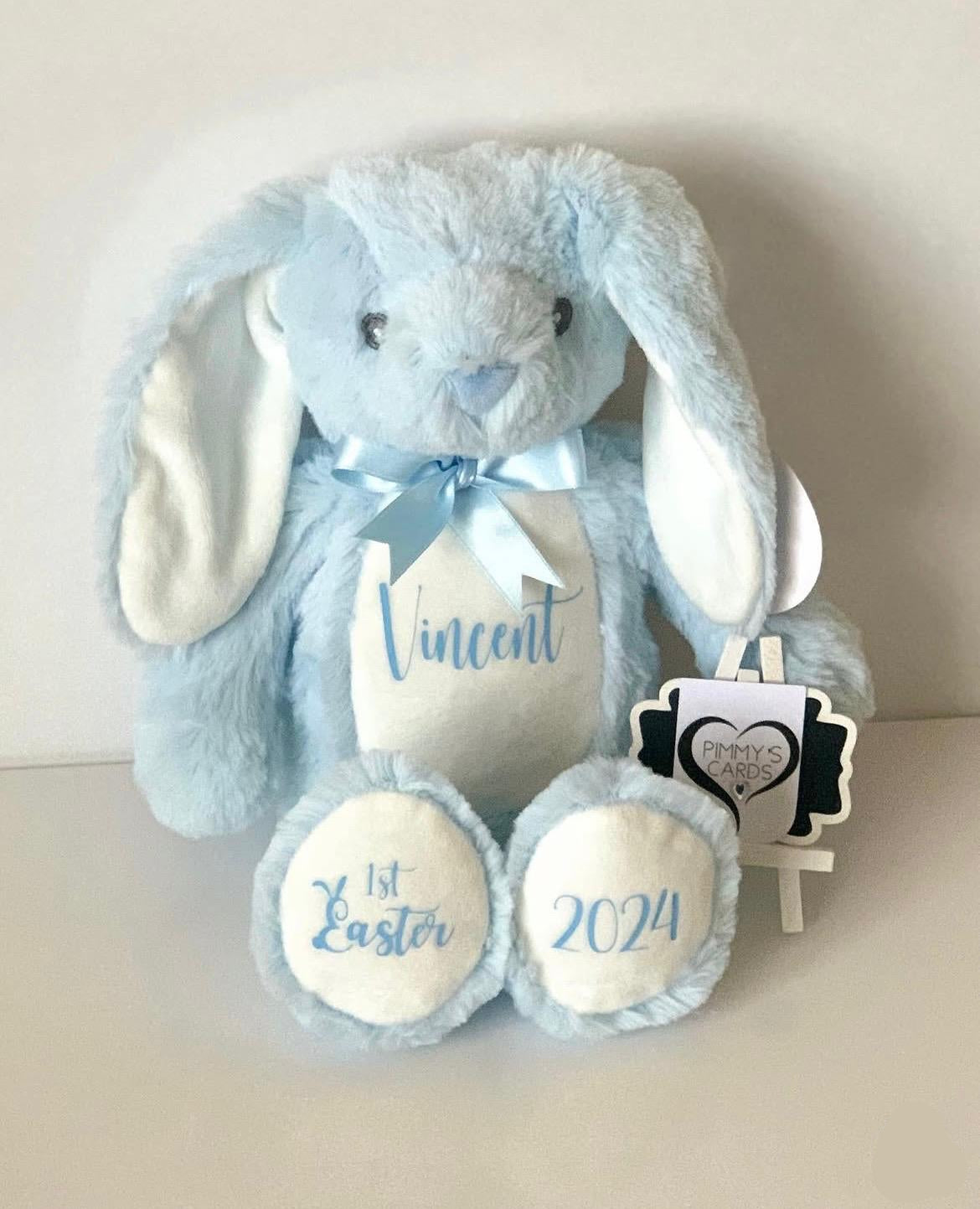 Blue plush bunny with personalised name and '1st Easter 2026' text on it. Personalised Soft Toy Bunny
